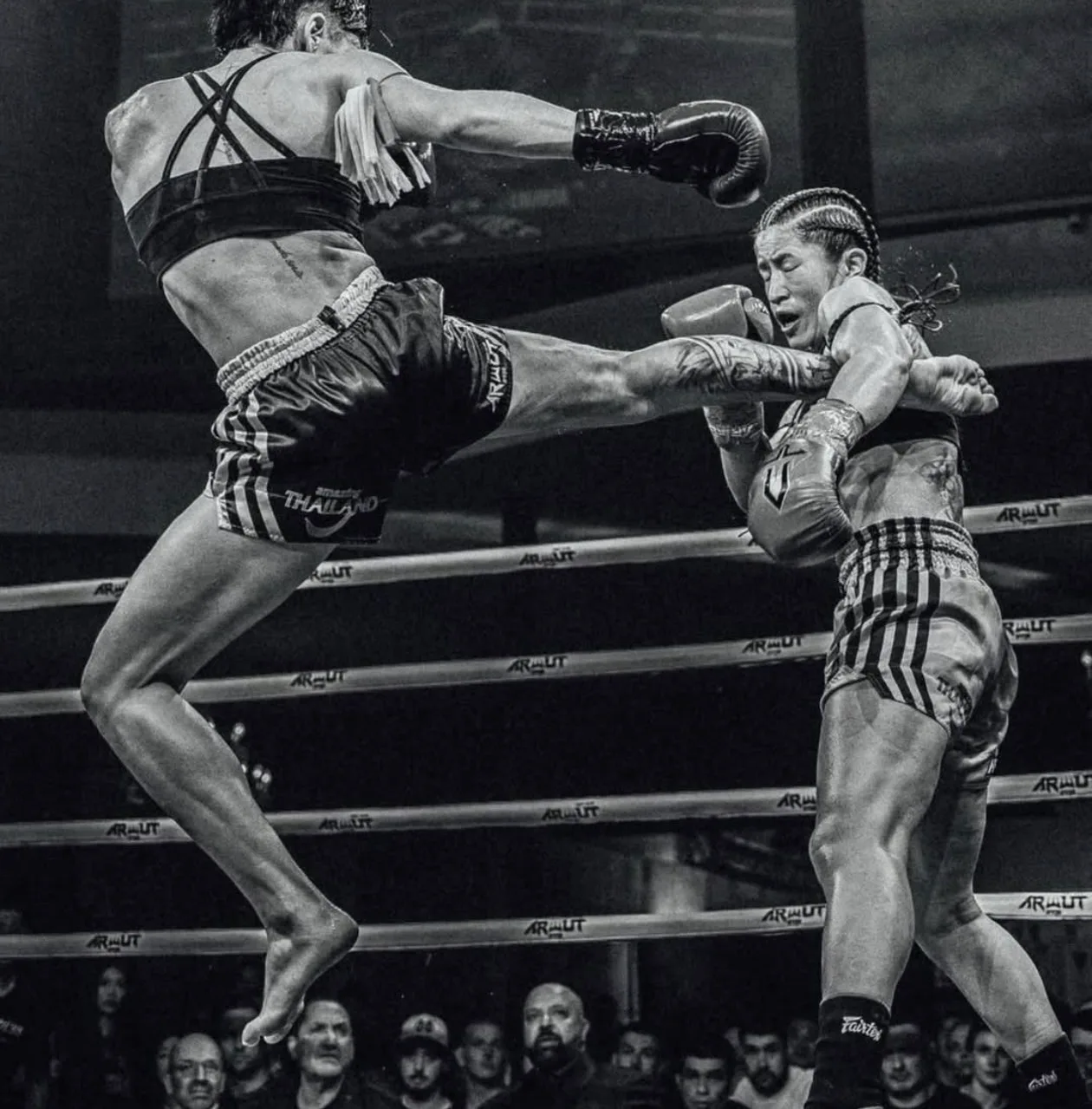 Combat athletes competing in a ring