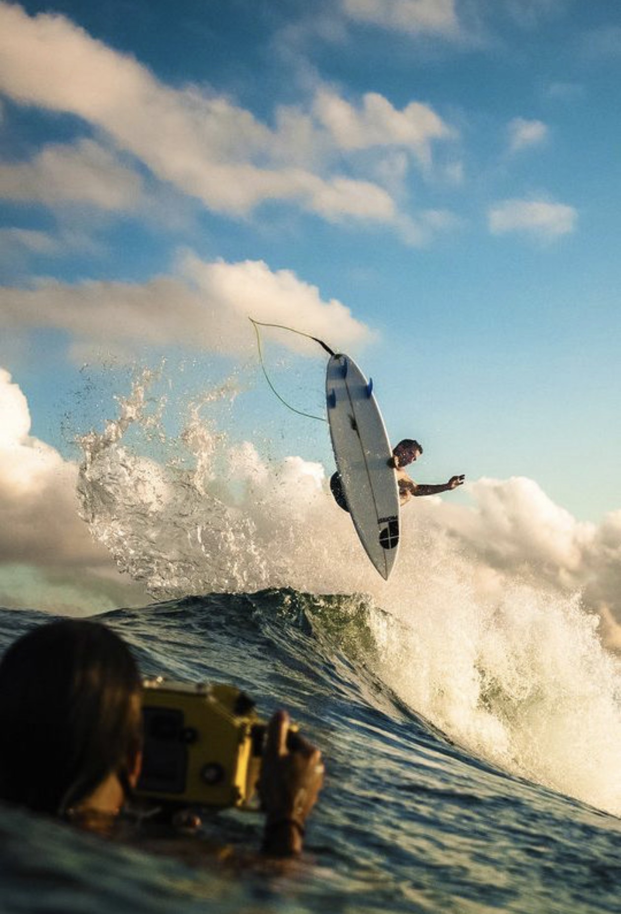 Surfer launching above a wave during a filmed session